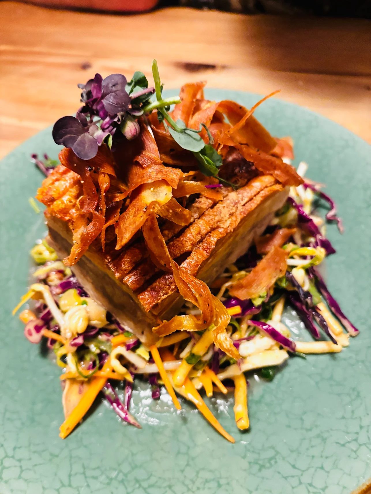Slow-roasted pork belly on a crispy bang bang salad