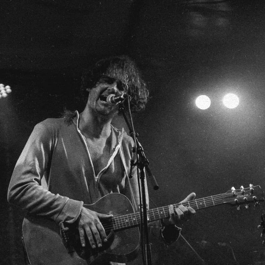 Julian Temple mid-set, guitar in hand
